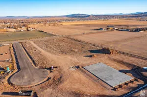 Aerial view of sparsely populated area featuring a mountain backdrop and a desert landscape