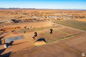 Aerial view of sparsely populated area with property boundaries highlighted and a desert landscape