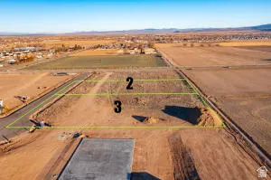 Overview of rural landscape with property boundaries highlighted and a mountainous background