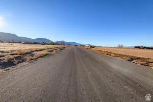 View of dirt / gravel road featuring a mountain view