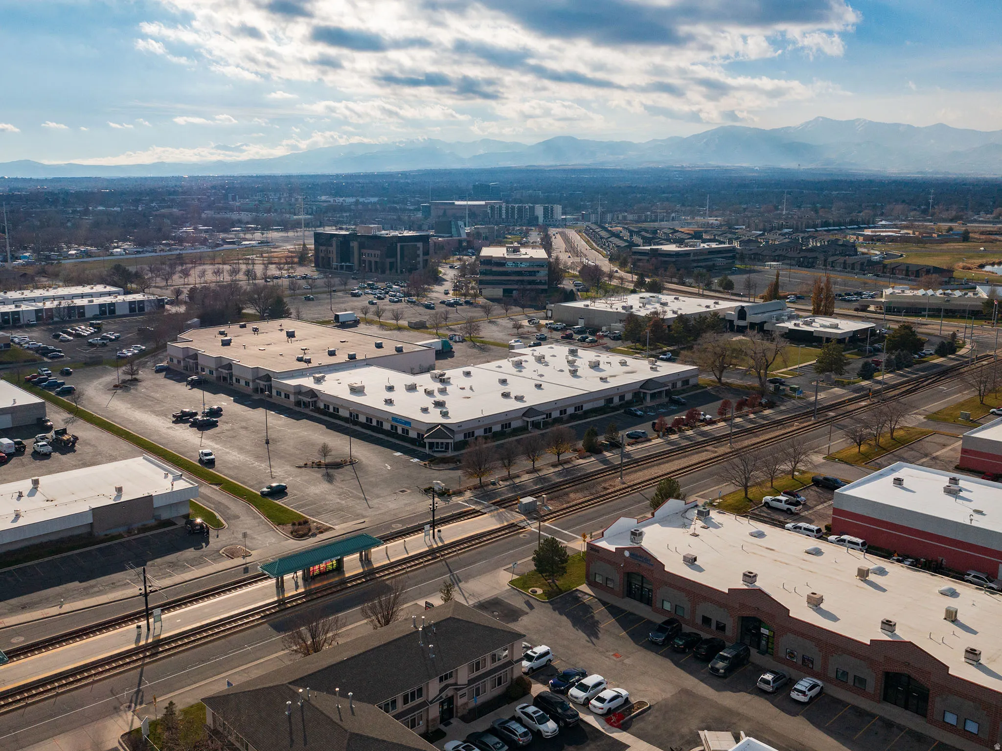 Drone / aerial view of a mountain backdrop and an industrial area