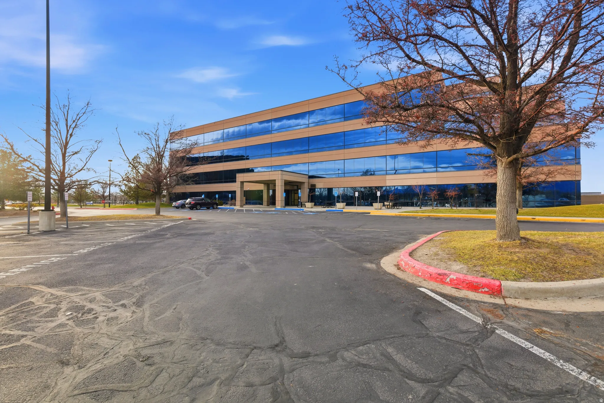 View of commercial property featuring uncovered parking