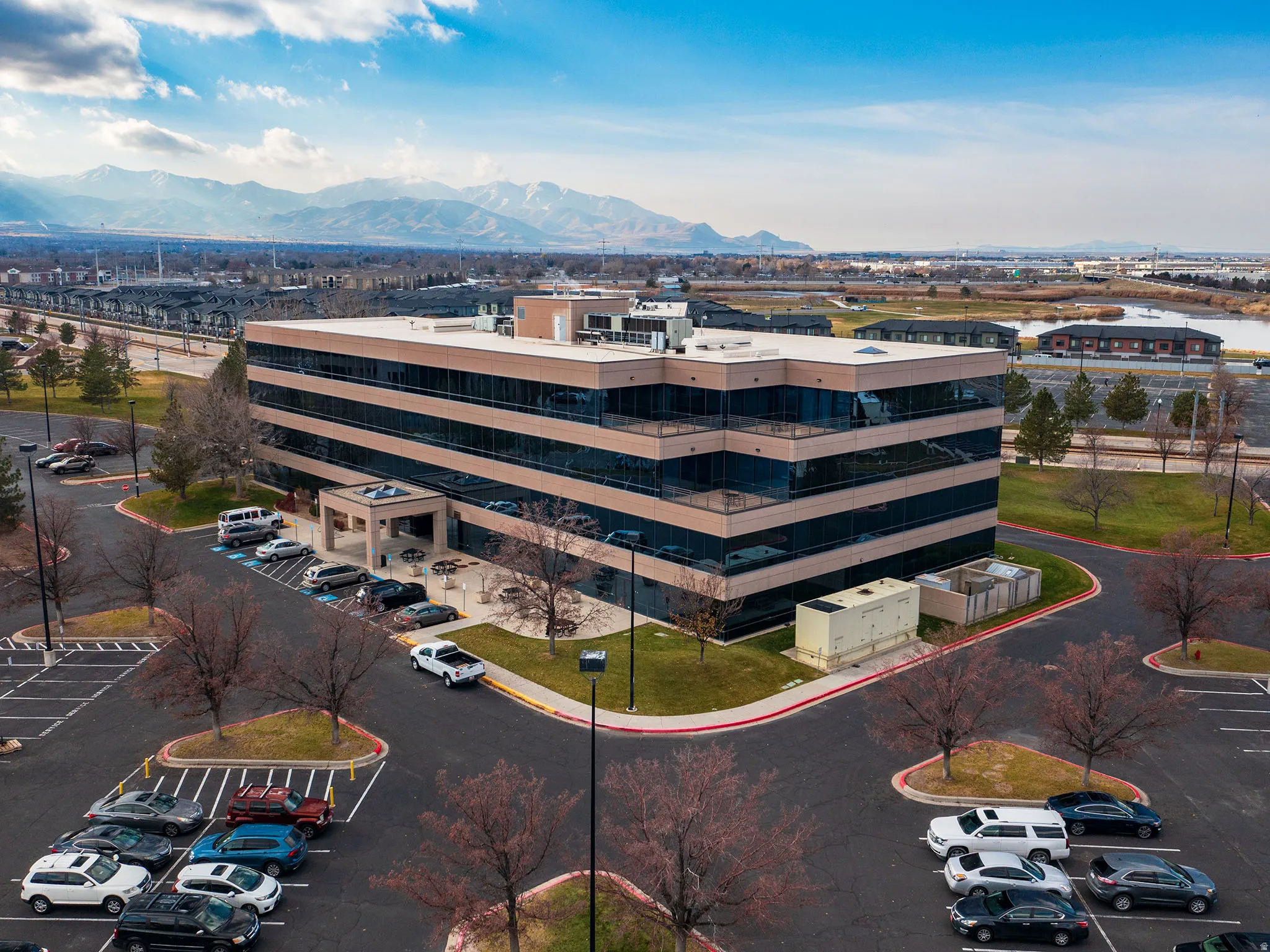 Drone / aerial view of apartment complex / building and a mountain backdrop