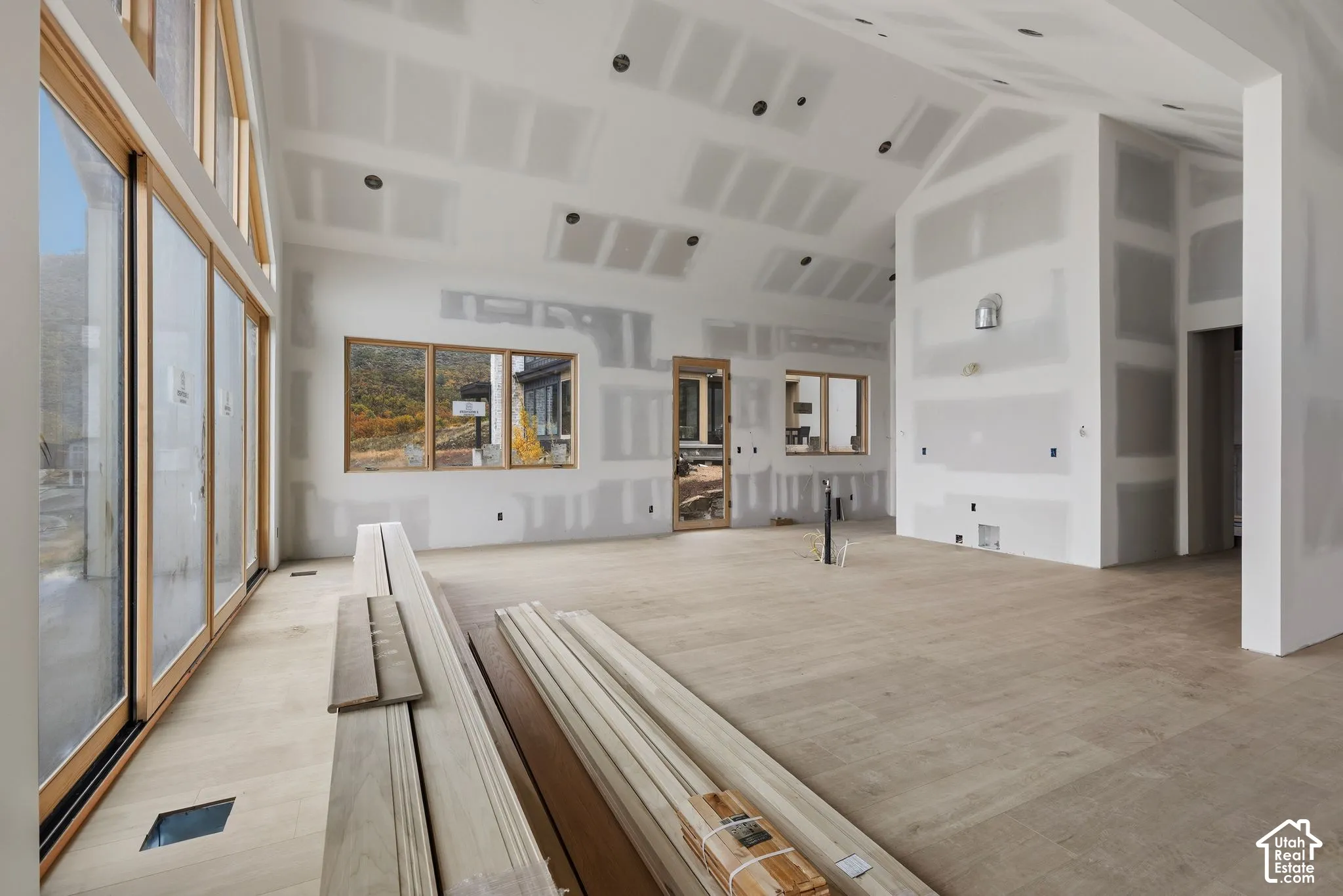 Vaulted ceilings, large-scale wood-frame windows, and wood-finish flooring