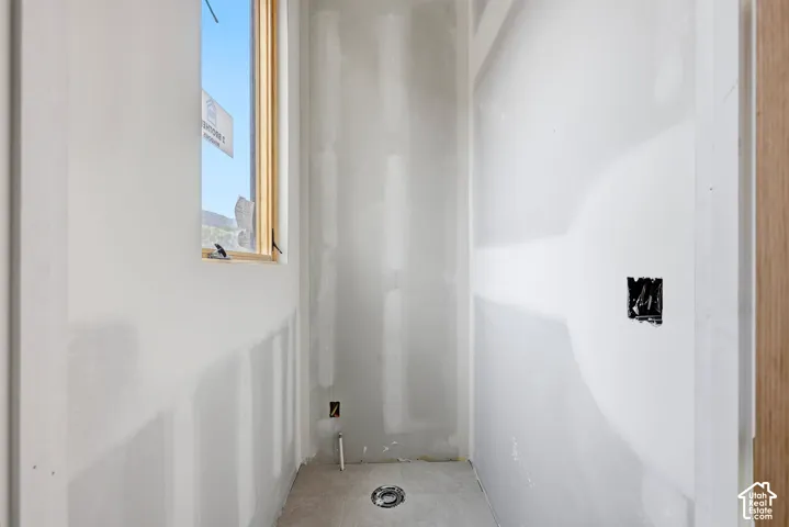 Vertical window with wood-trim framing and tile flooring