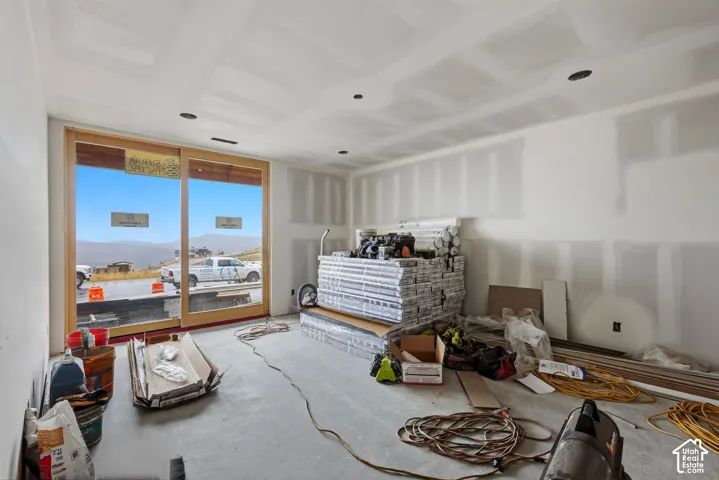Expansive sliding glass door with wood-finish frame and recessed ceiling lighting