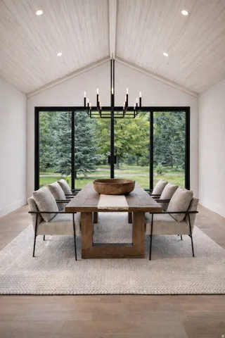 Dining space featuring wood finished floors, a chandelier, wooden ceiling, and plenty of natural light