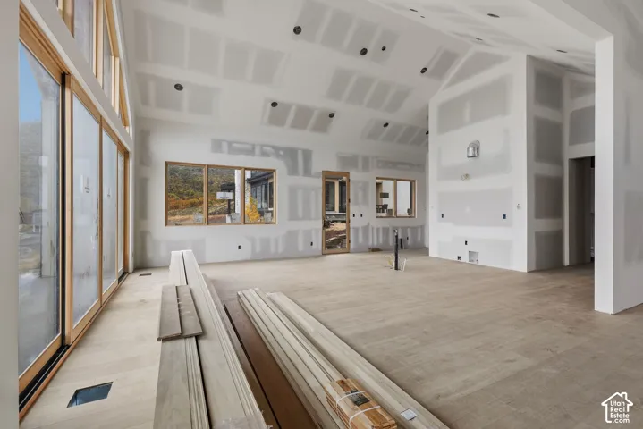 Vaulted ceilings, large-scale wood-frame windows, and wood-finish flooring