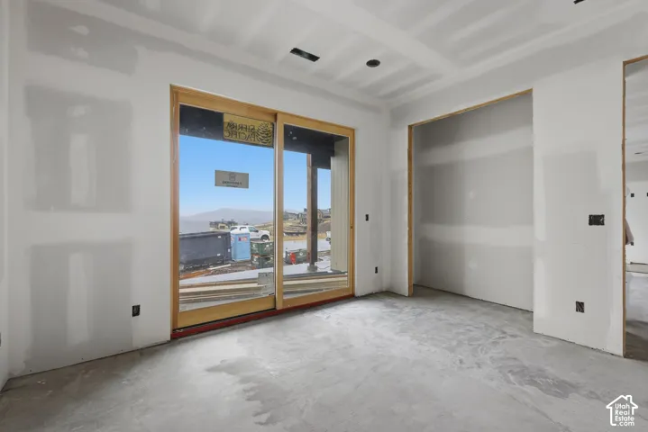 Sliding glass door with wood-finish frame and recessed ceiling lighting