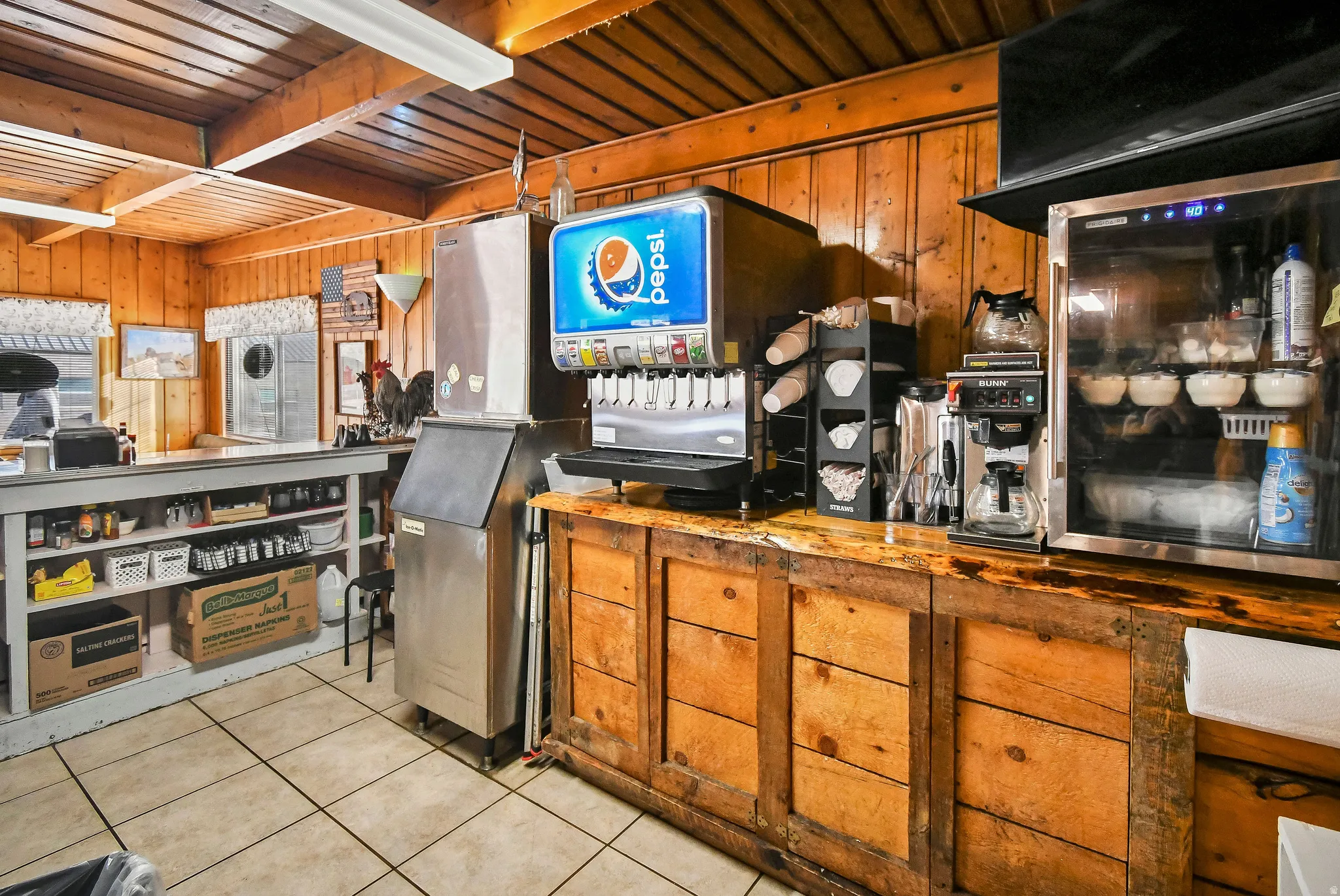 Kitchen with wood counters, wooden ceiling, brown cabinetry, and wood walls
