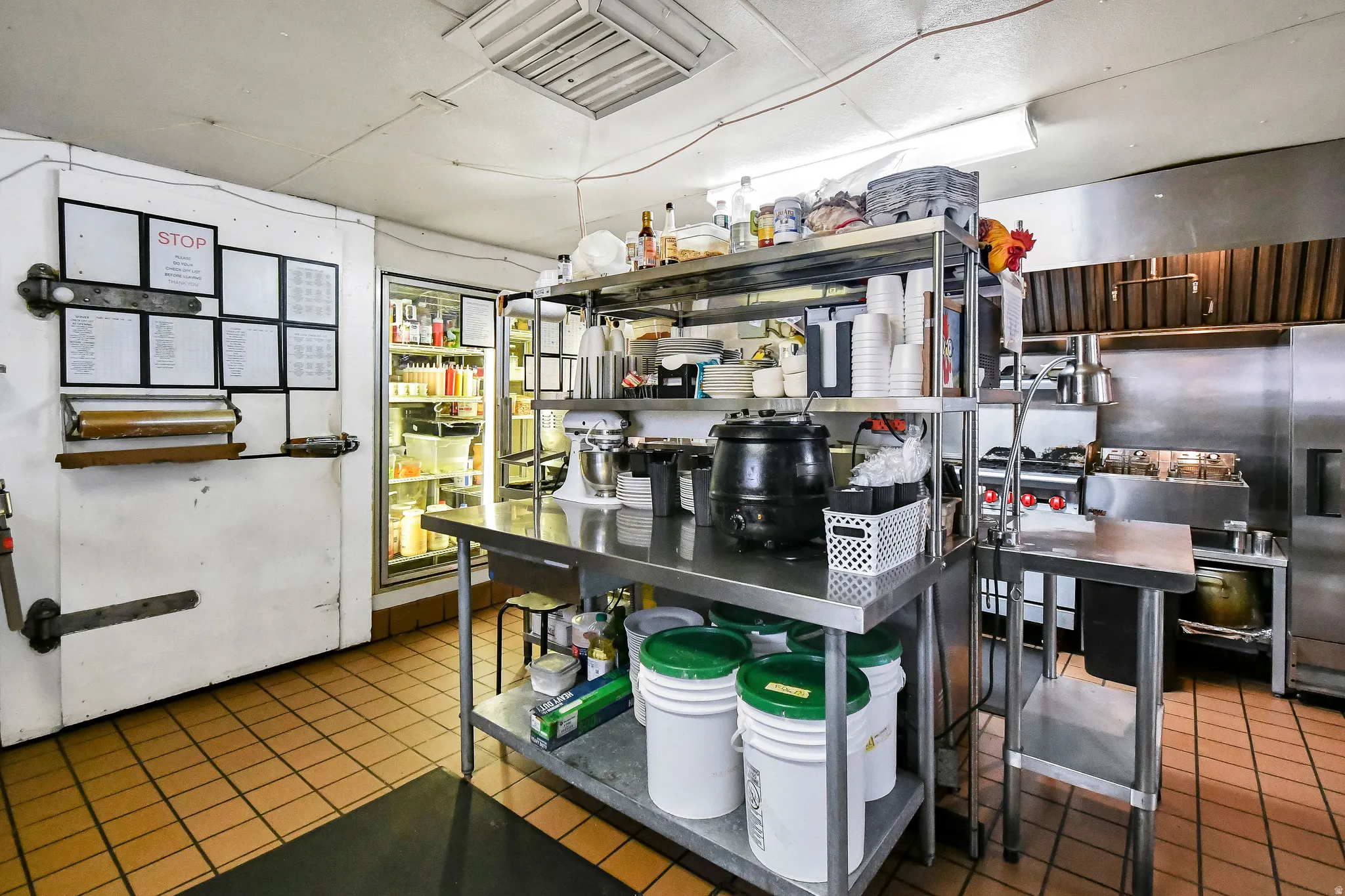 Kitchen with cooling unit and stainless steel fridge