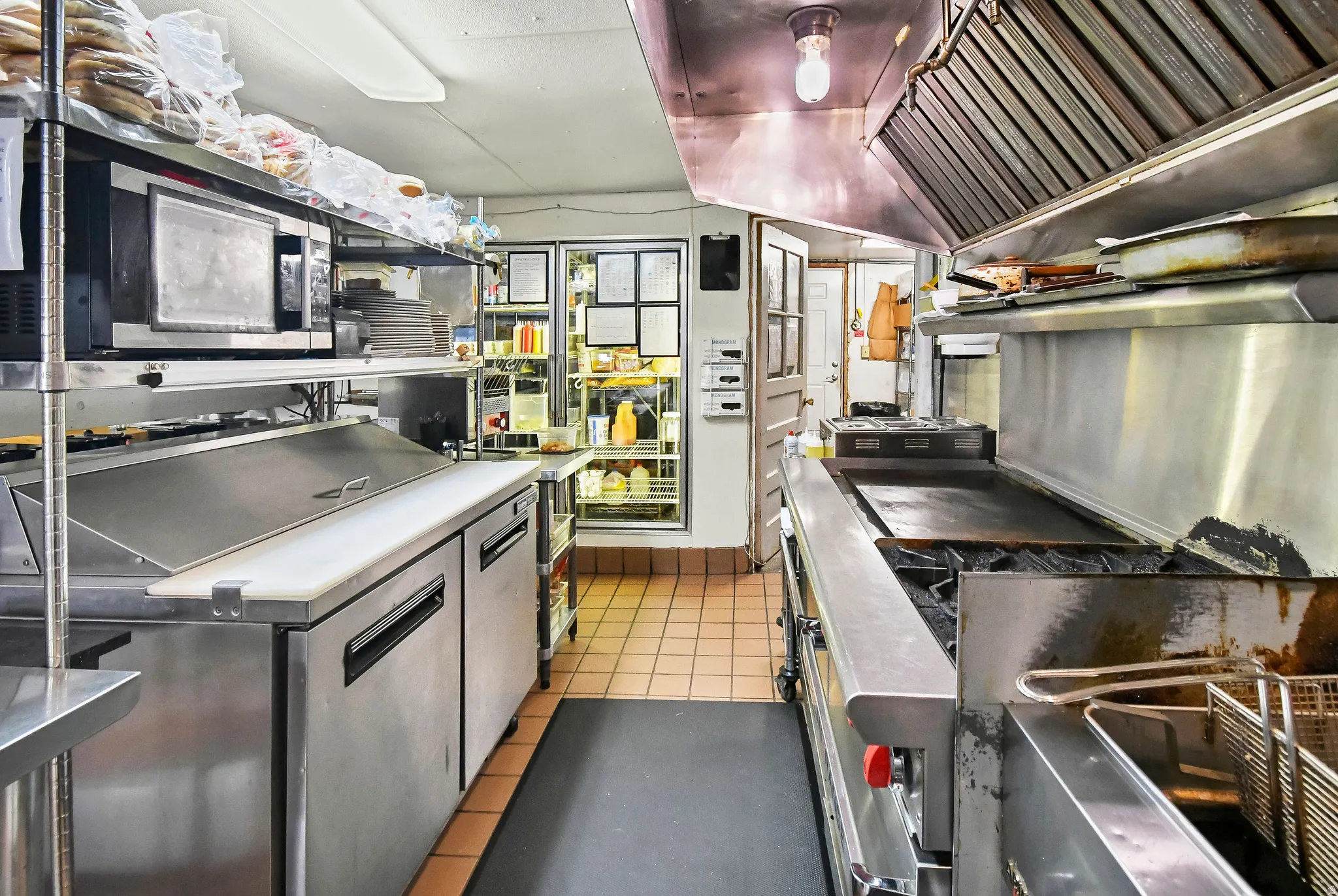 Kitchen featuring lofted ceiling and stainless steel microwave