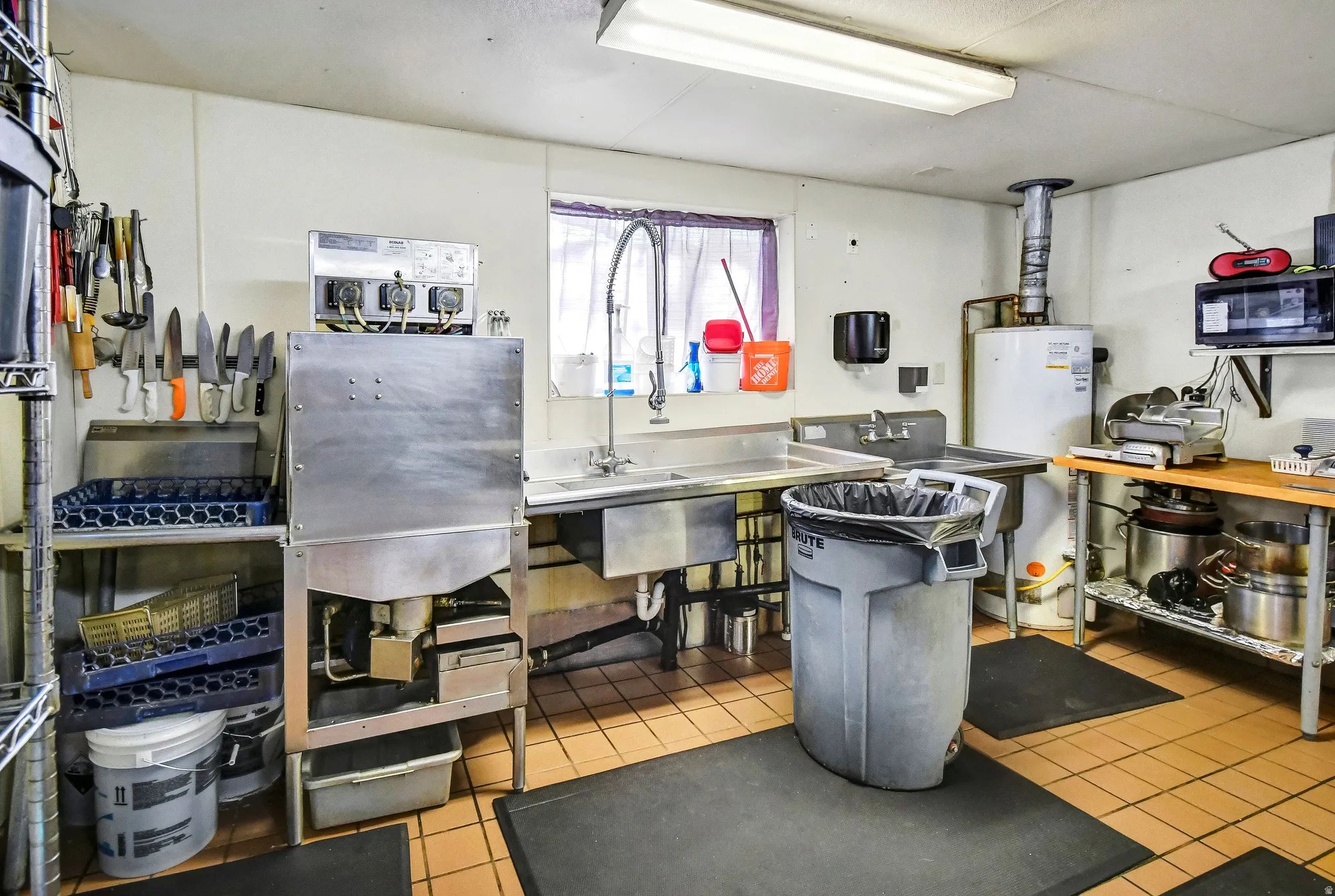 Kitchen with water heater and stainless steel countertops