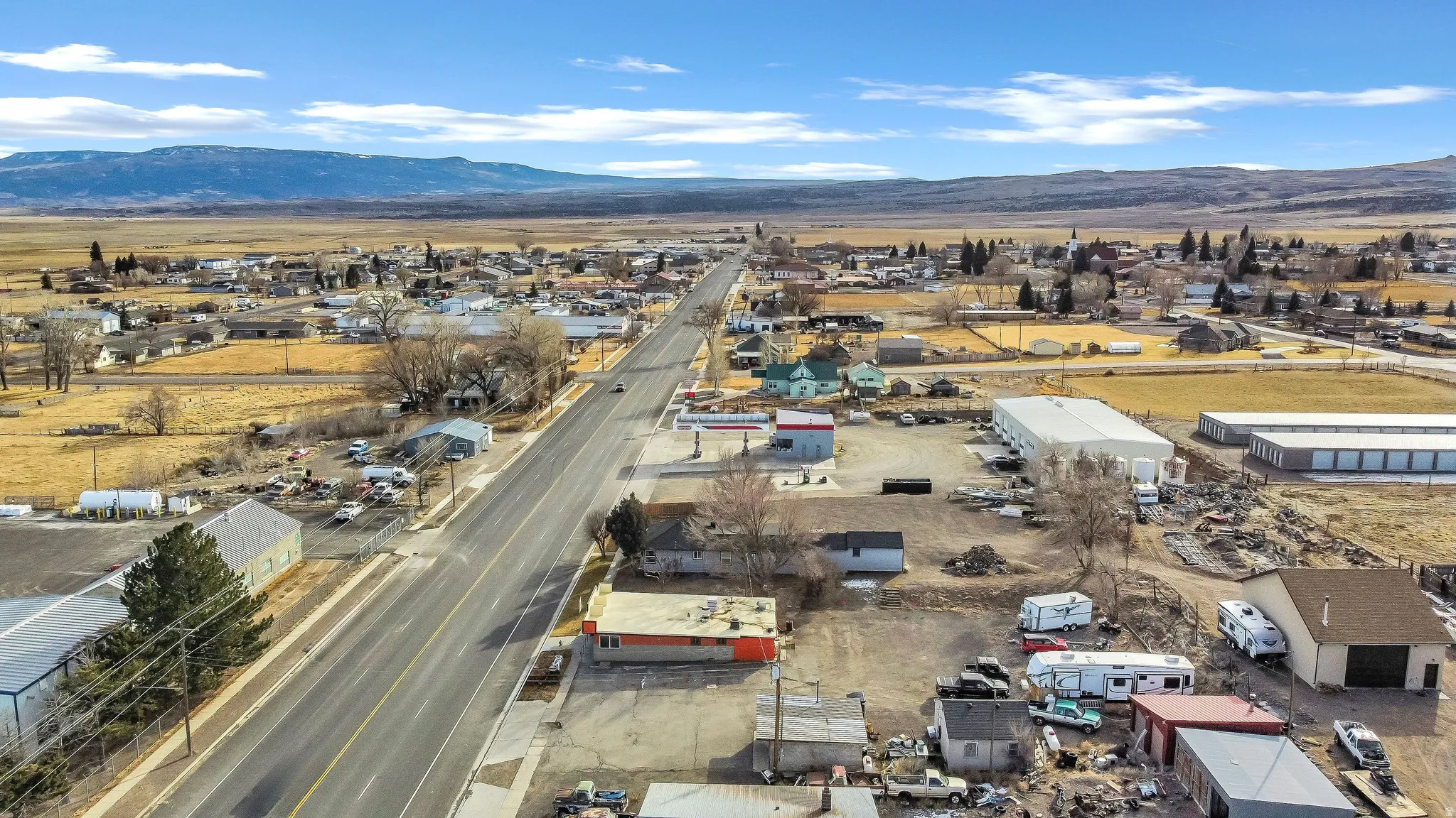 Aerial view of a mountain backdrop and industrial structures