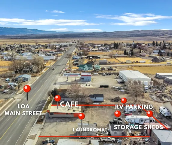 Aerial overview of property's location featuring a mountainous background and property boundaries highlighted