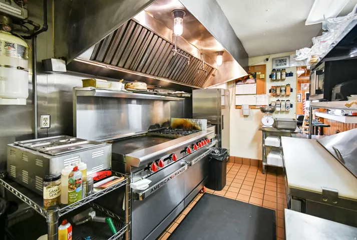 Kitchen featuring freestanding refrigerator