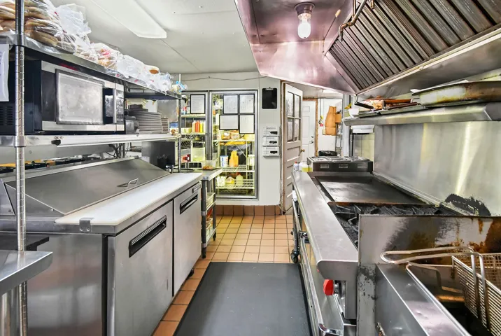 Kitchen featuring lofted ceiling and stainless steel microwave