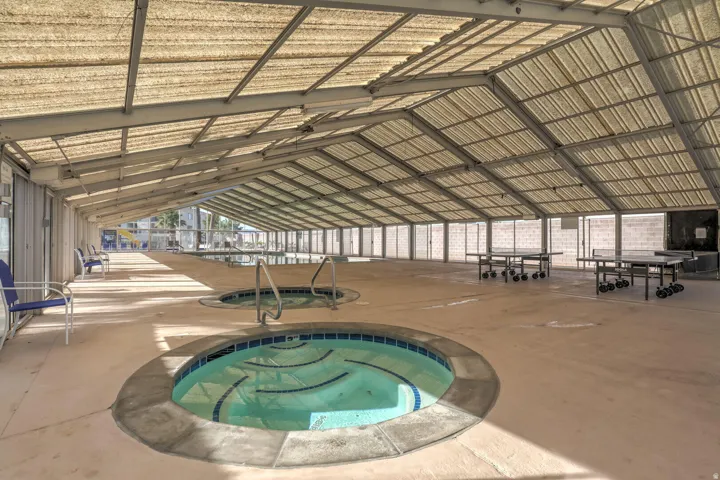 View of pool featuring a patio area and a community hot tub