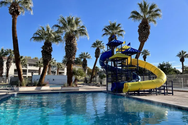 Community pool featuring a water slide