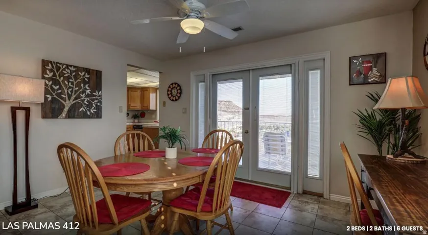 Dining room featuring a ceiling fan, tile patterned floors, and french doors