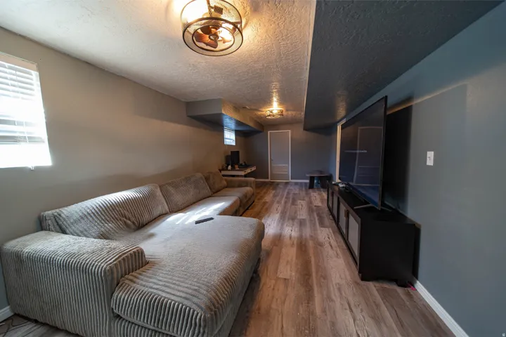 Living room featuring wood finished floors and a textured ceiling