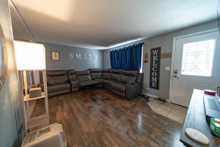 Living area with dark wood finished floors and a textured ceiling