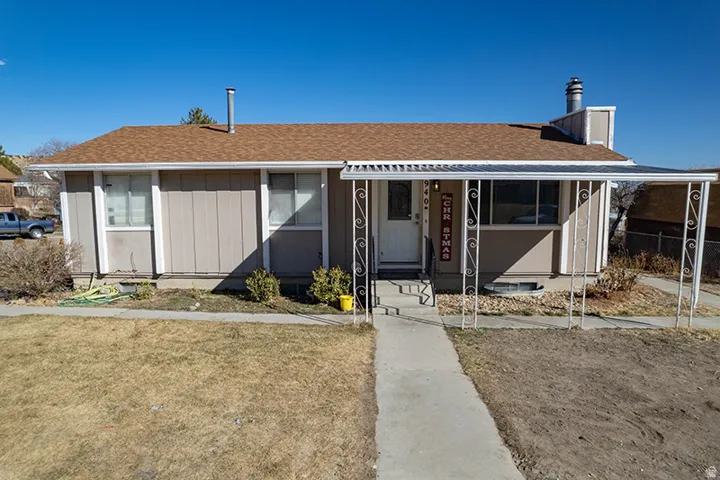 View of front of home featuring roof with shingles and a front yard
