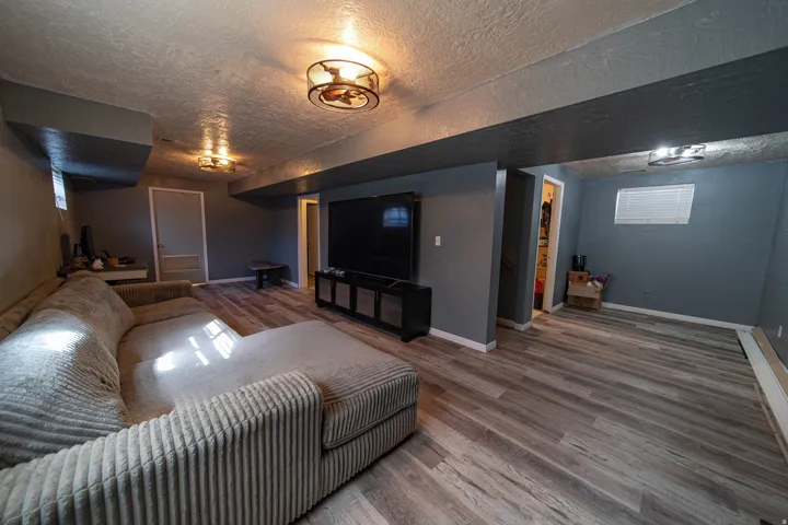 Living room featuring wood finished floors and a textured ceiling