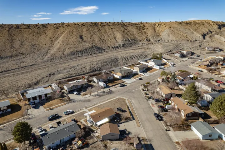 Aerial view of property's location featuring nearby suburban area and mountains