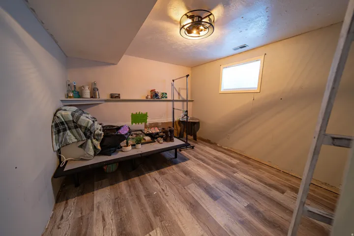 Sitting room with light wood-style flooring and a textured ceiling