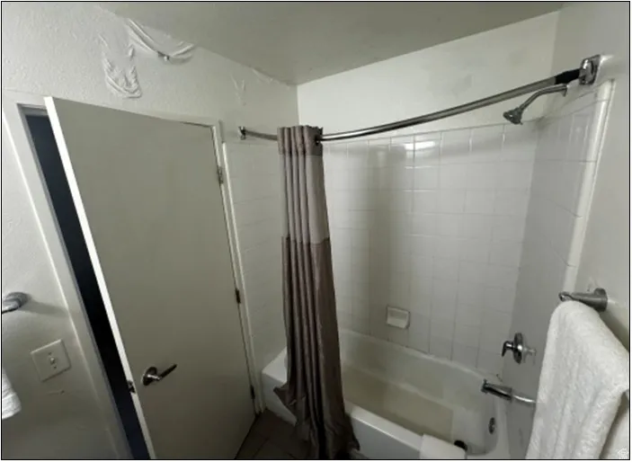 Full bathroom featuring shower / tub combo and tile patterned floors