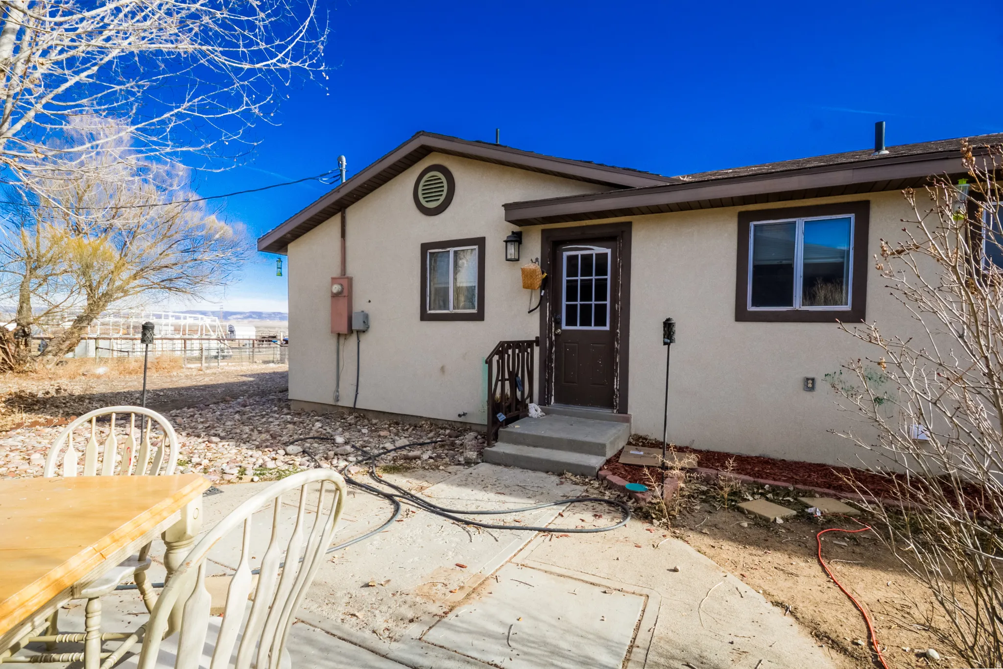 Back of property featuring stucco siding