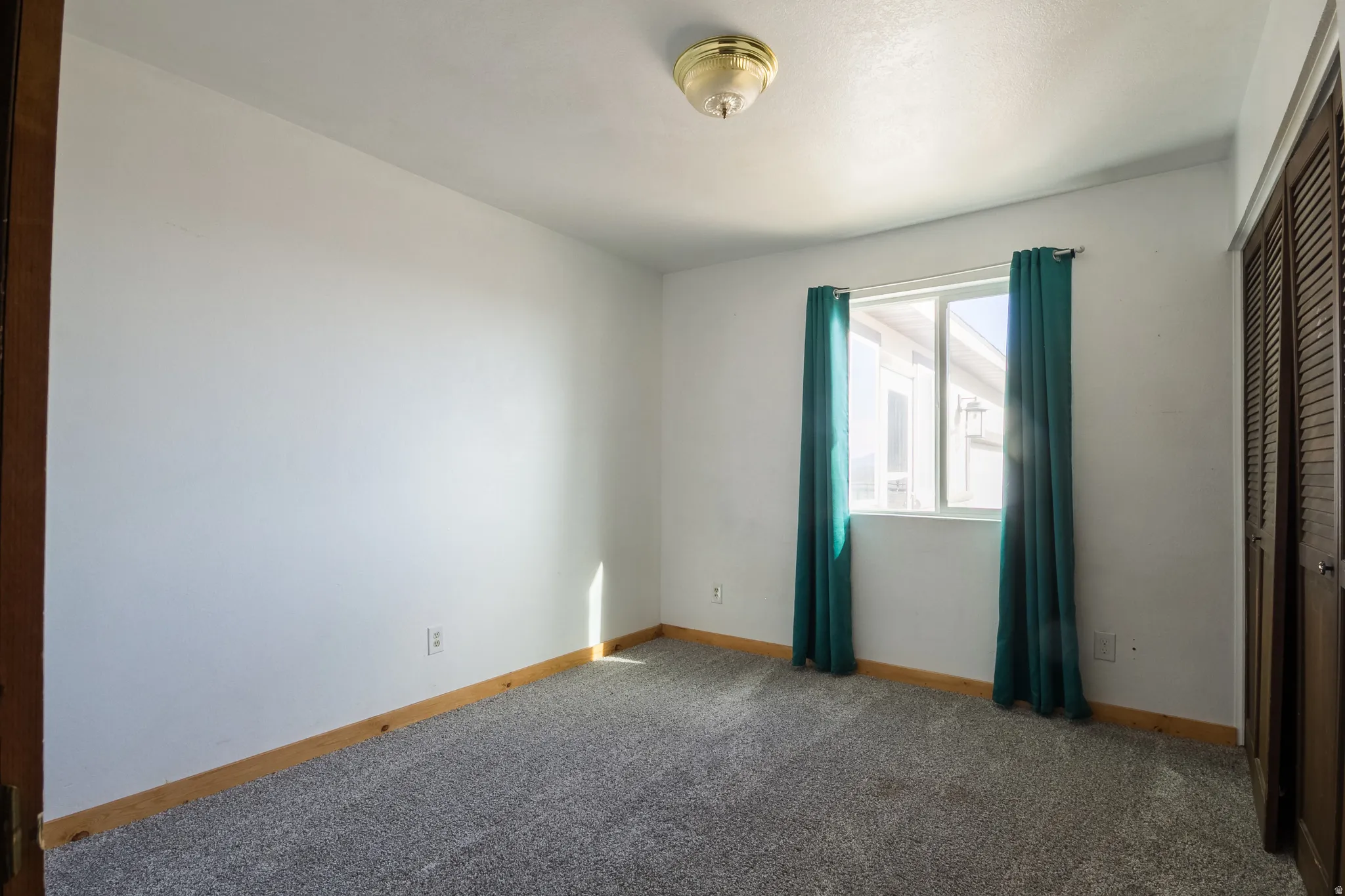 Unfurnished bedroom featuring a closet and carpet floors