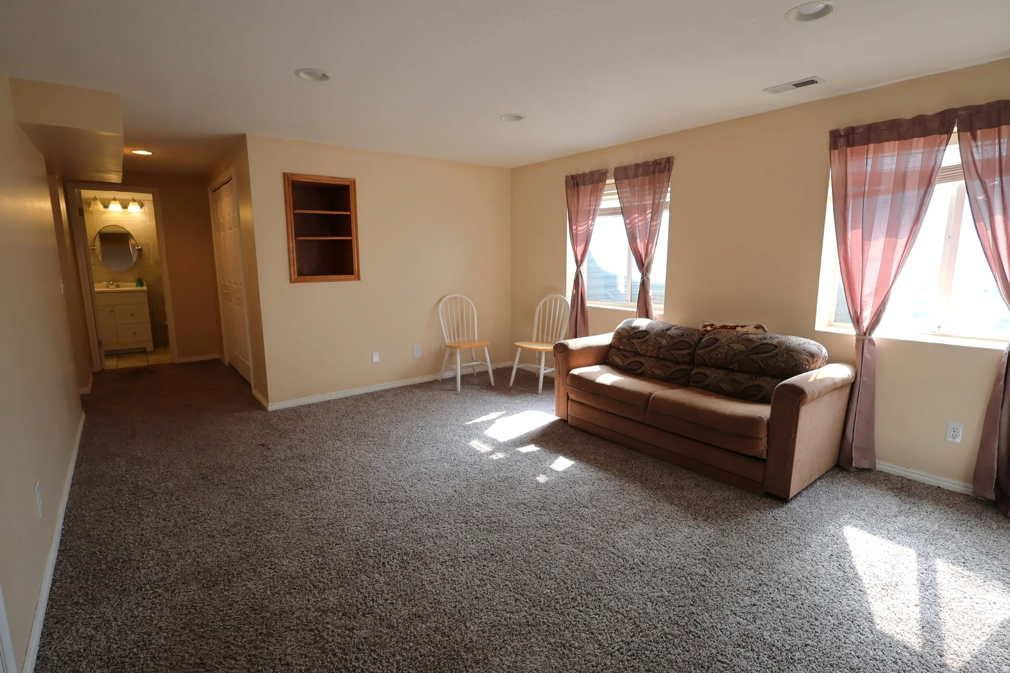 Living area with carpet floors and recessed lighting