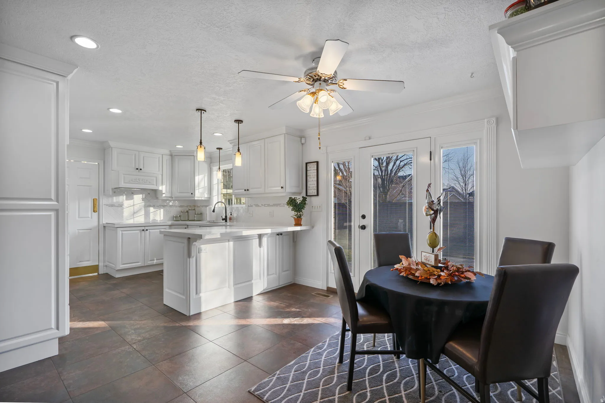 Breakfast nook with crown molding, a textured ceiling, ceiling fan, and recessed lighting