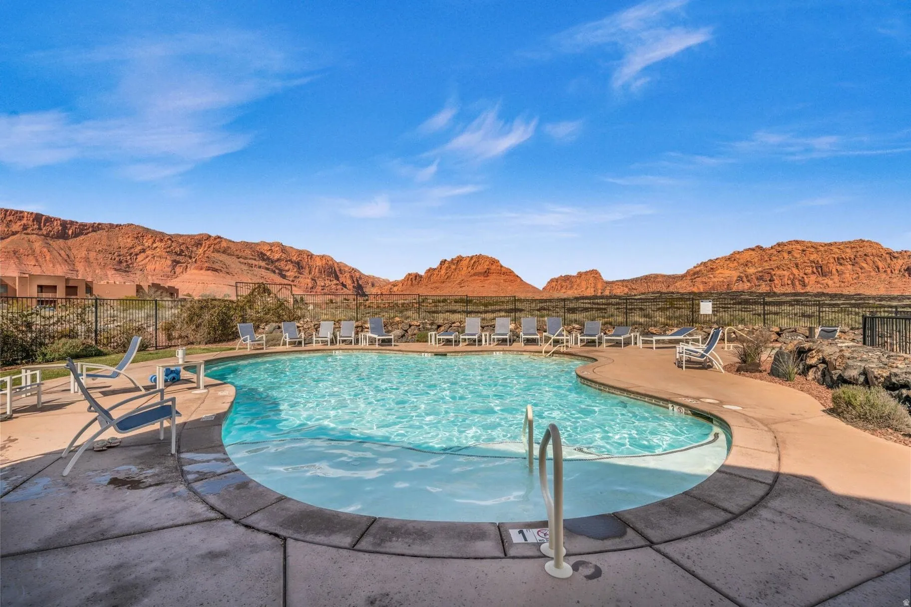 Community pool featuring a mountain view and a patio