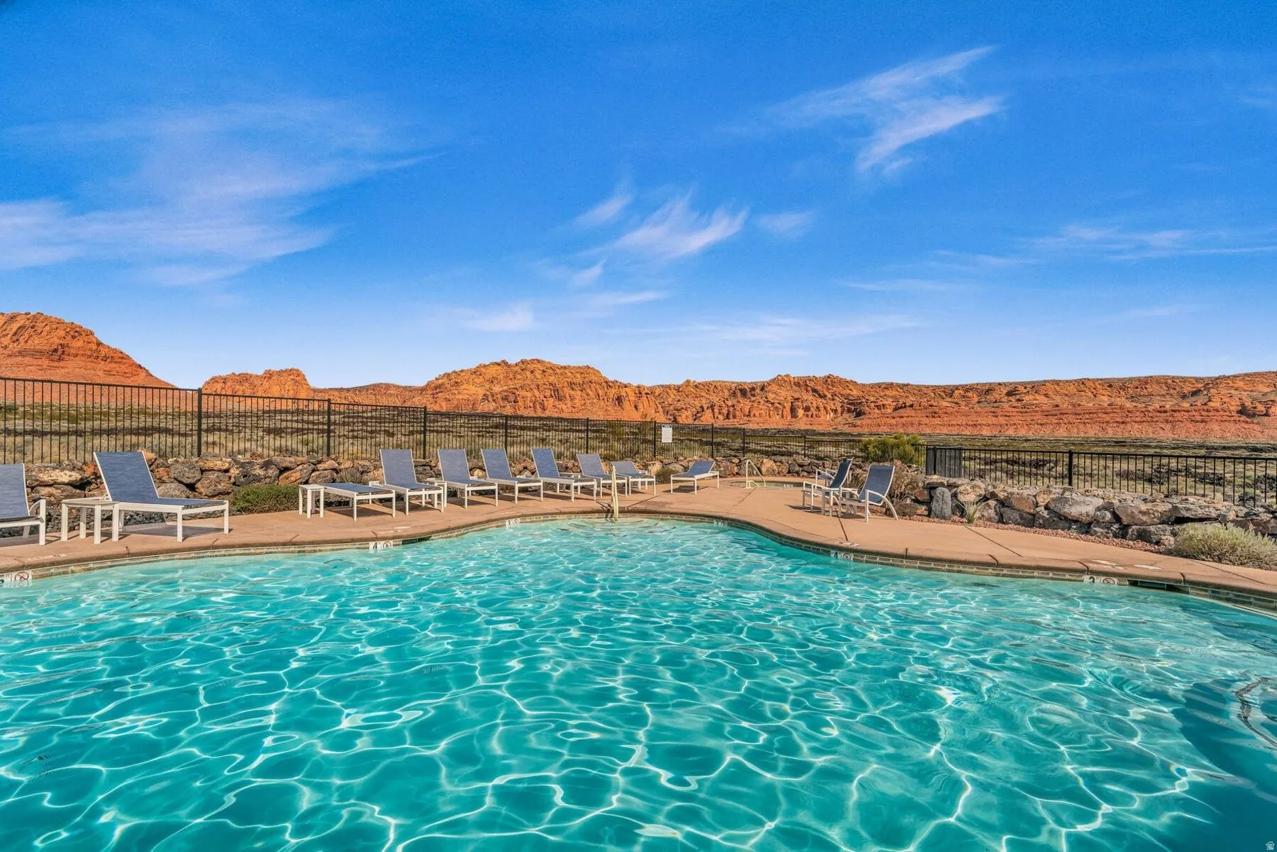 Community pool featuring a mountain view and a patio area