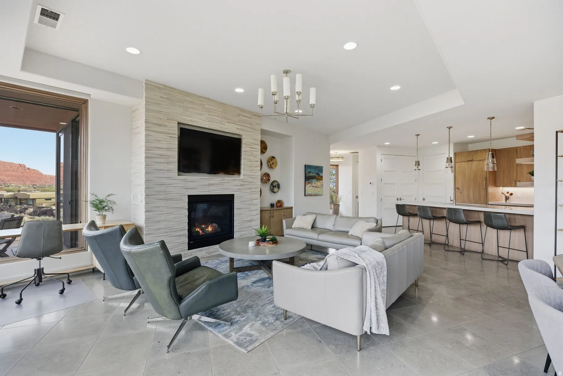 Living area with a chandelier, a tiled fireplace, recessed lighting, and light tile patterned flooring