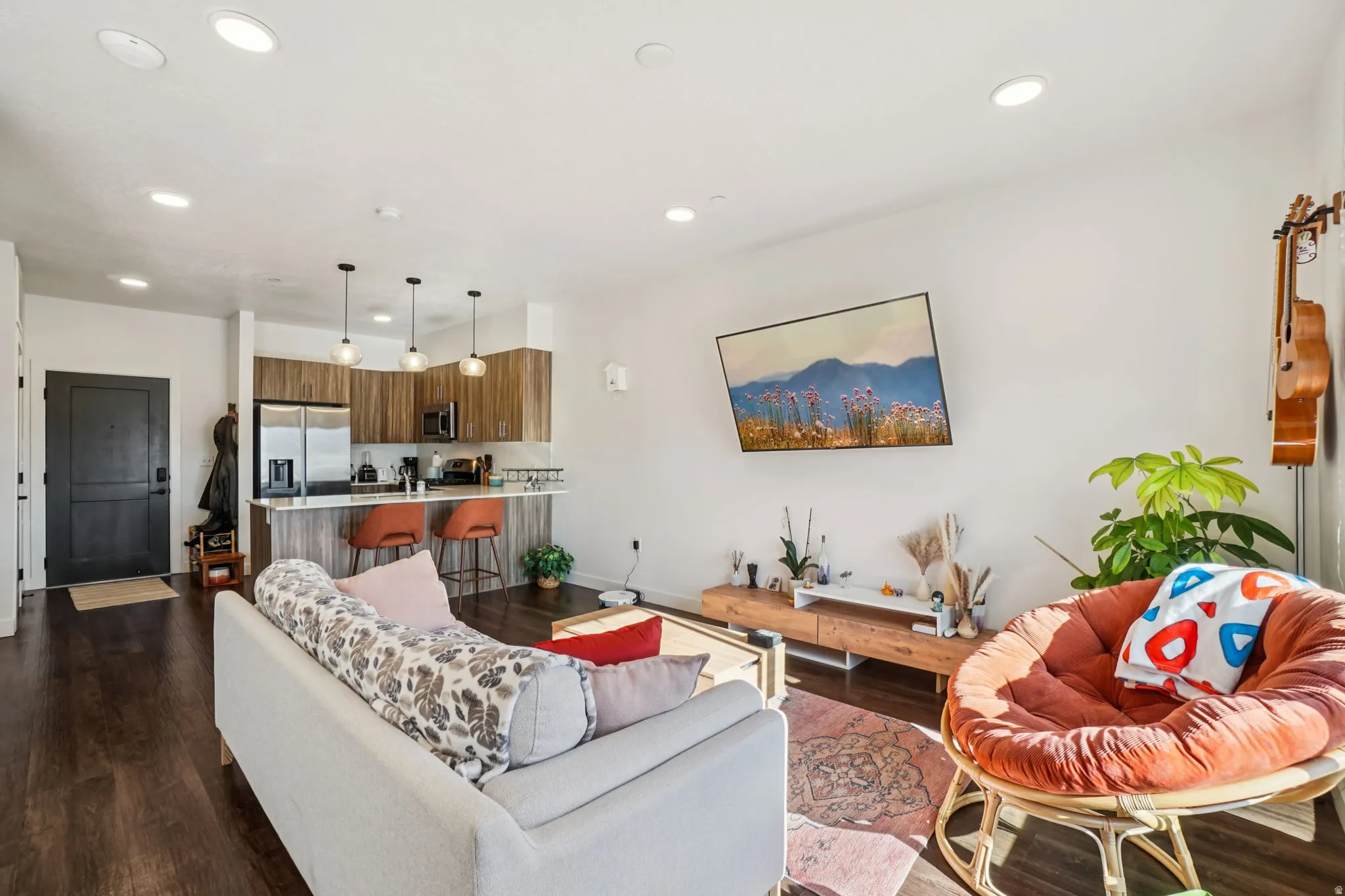 Living area with dark wood finished floors and recessed lighting