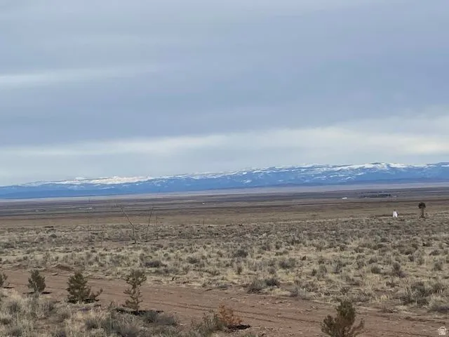 View of mountain backdrop with rural landscape and a desert landscape