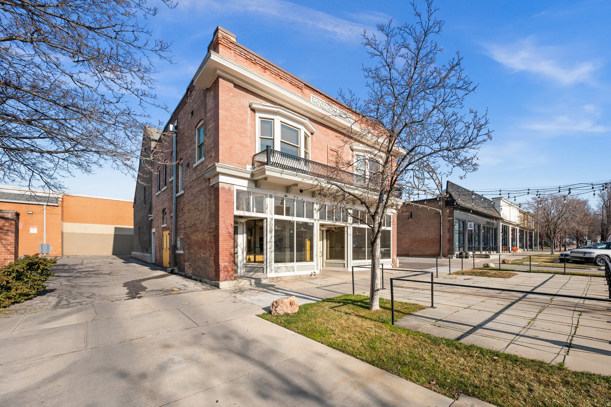 View of front of property featuring brick siding and a balcony