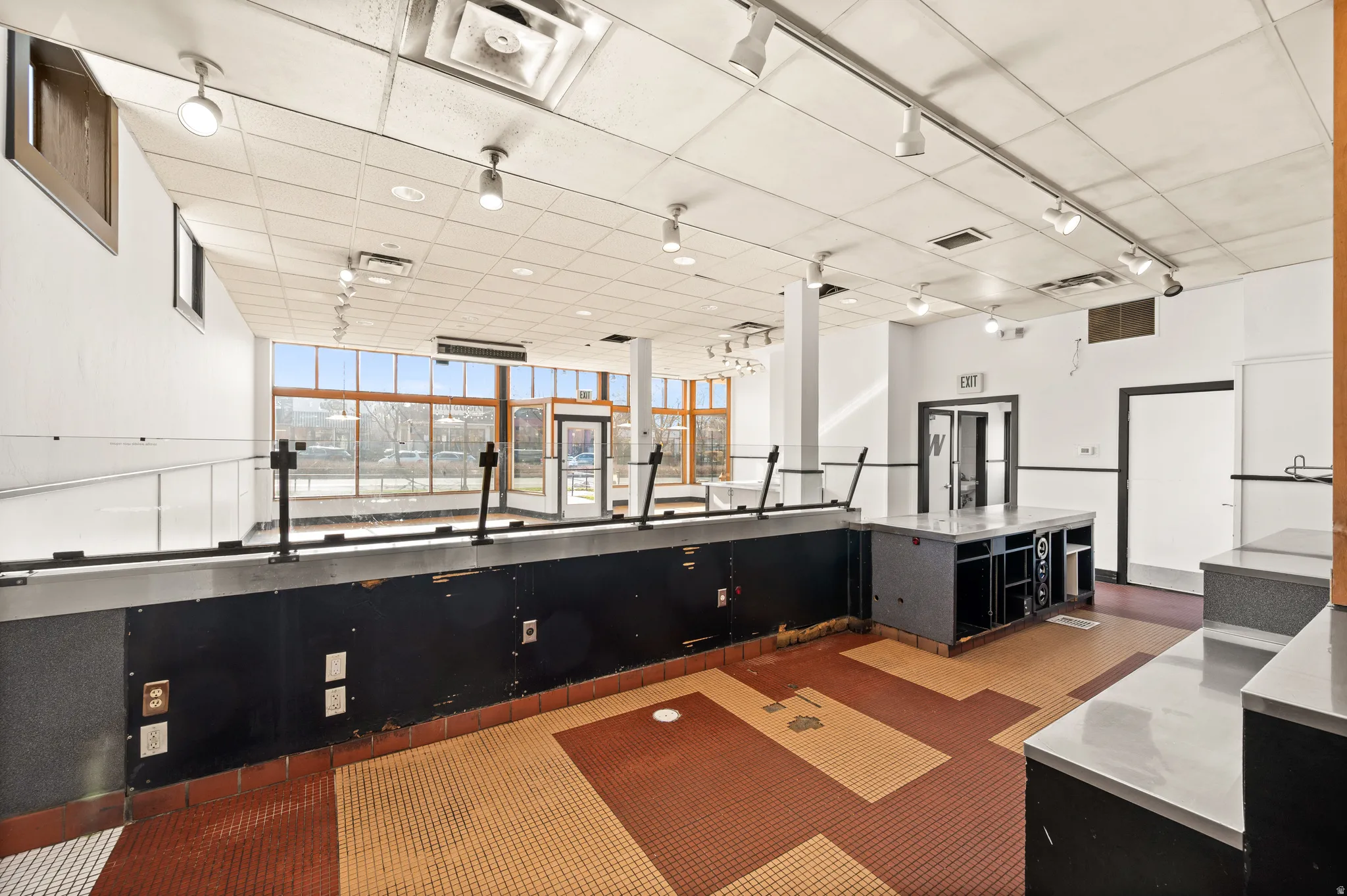 Bar area featuring dark cabinets and stainless steel counters