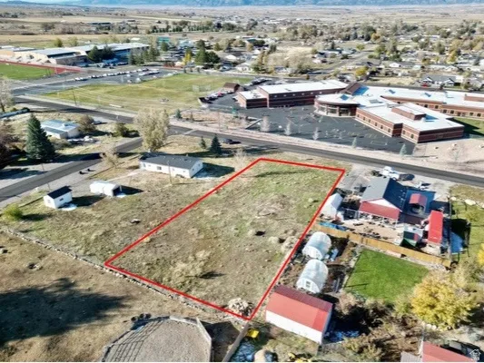 Aerial view of property and surrounding area with property boundaries highlighted and an industrial area