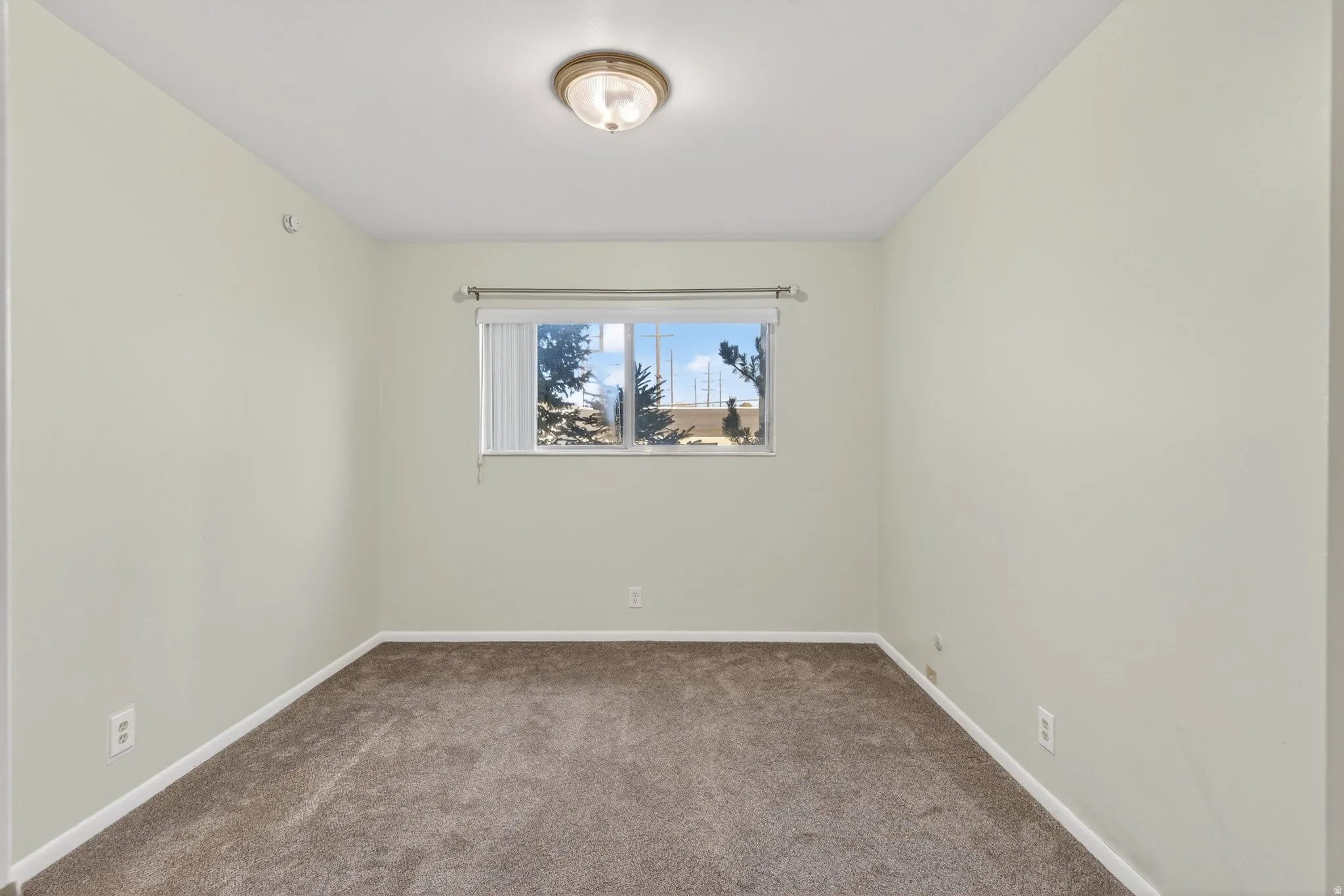 Empty room featuring carpet floors and baseboards