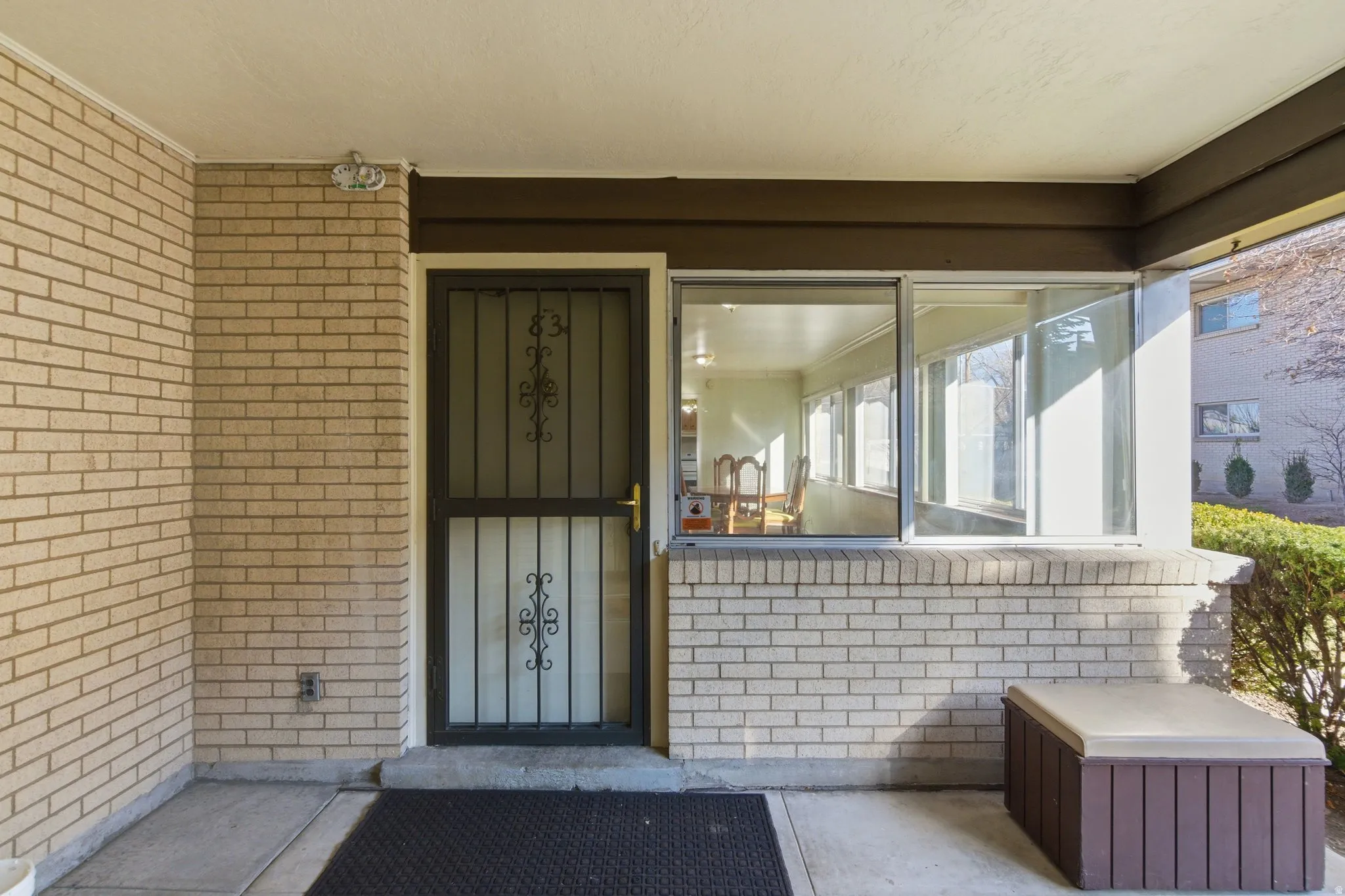 View of exterior entry with brick siding