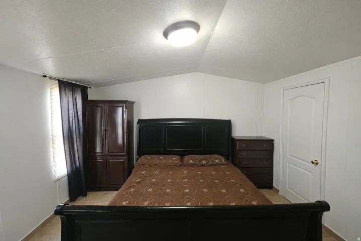 Bedroom featuring a decorative wall