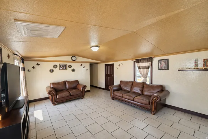 Living room featuring a textured ceiling and baseboards