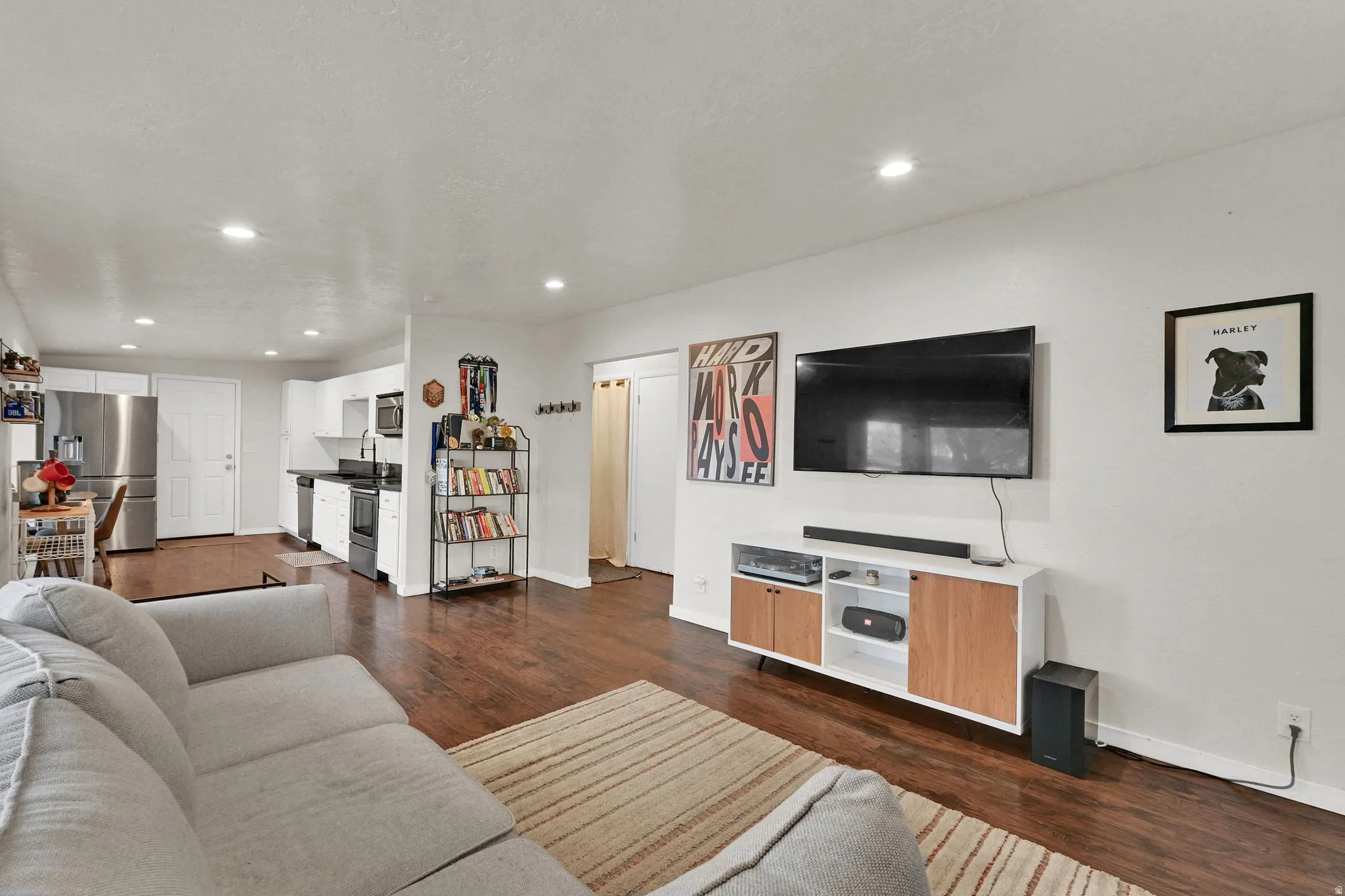 Living room with dark wood-style flooring and recessed lighting