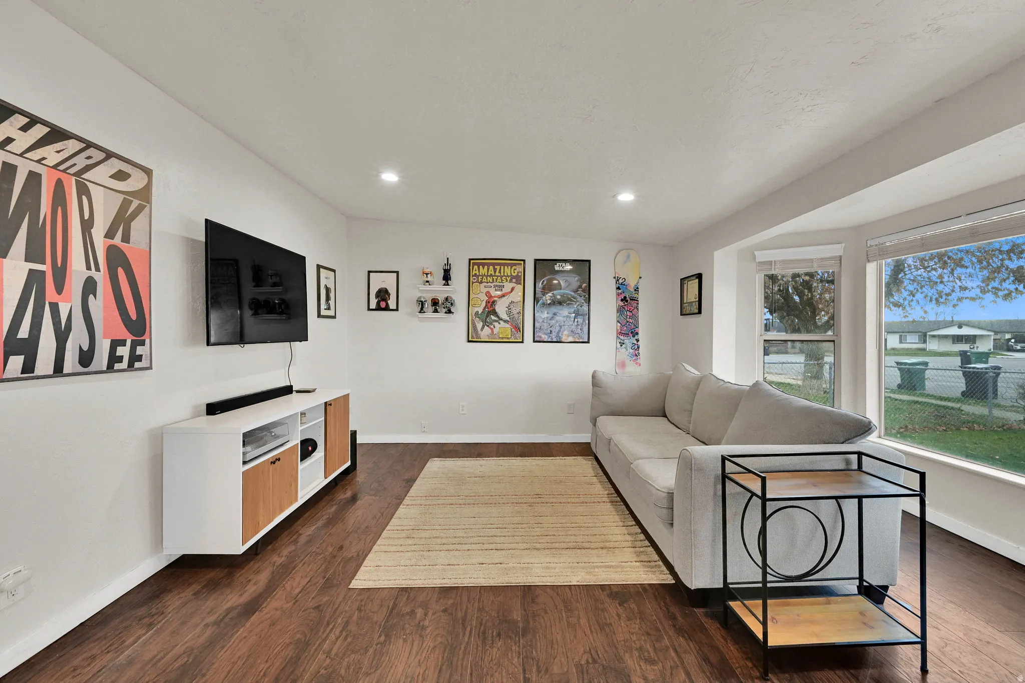 Living room with dark wood finished floors and recessed lighting