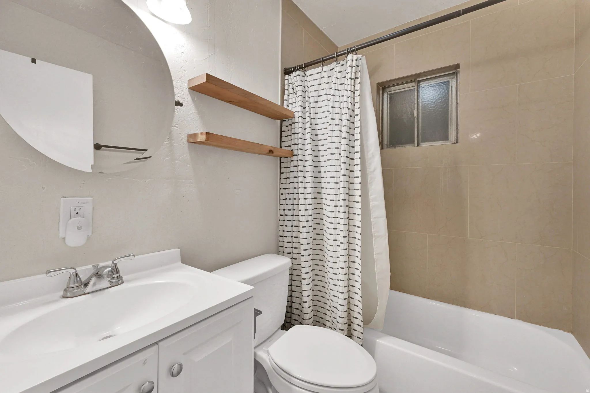Bathroom featuring vanity and shower / tub combo